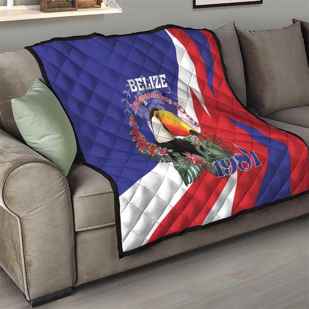 Blue red and white Belize Independence 1981 quilt draped on sofa, toucan graphic centered.