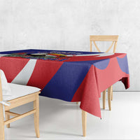 Blue, red, and white patterned tablecloth draped over dining table