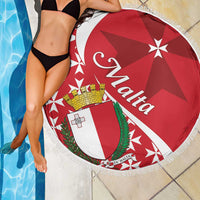 Red round beach blanket featuring crest shield, star rays, and Malta Cross with white fringe