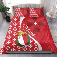 Red bedding set with Malta crest banner and Maltese cross star pattern, shown on a bed