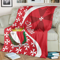 Red Malta themed throw blanket on sofa with Maltese cross star pattern and white shield