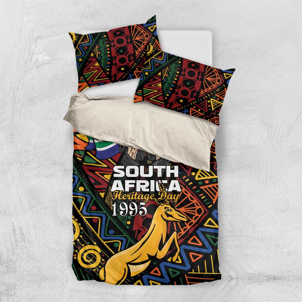 Bedding set top view: geometric springbok print duvet and two pillowcases with 'Heritage Day 1995'