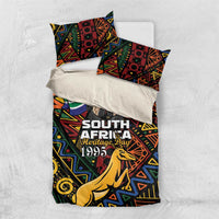 Bedding set top view: geometric springbok print duvet and two pillowcases with 'Heritage Day 1995'