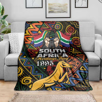 Black blanket over sofa with springbok graphic and Heritage Day 1995 lettering.