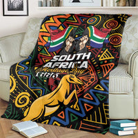 Black blanket over couch with colorful African geometric pattern, springbok and Heritage Day 1995.