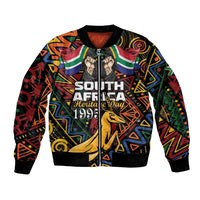 Black bomber jacket with colorful African pattern, front zip, ribbed cuffs, springbok graphic