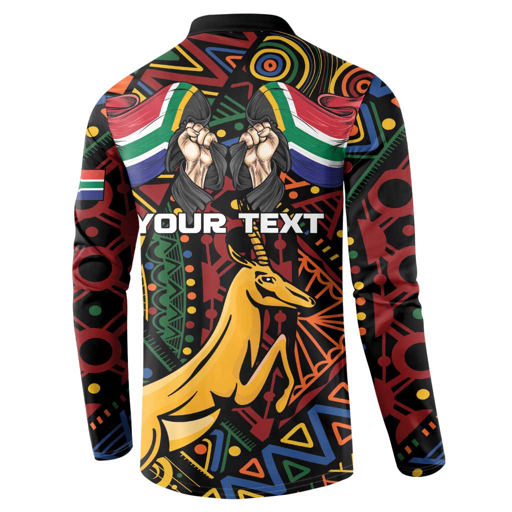 Black button sweatshirt with colorful African pattern, hands graphic, and springbok text