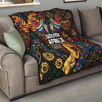South Africa Heritage Day quilt on sofa, springbok and vibrant geometric tribal pattern.