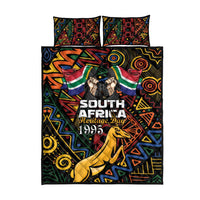 Black quilt bed set with colorful geometric pattern, springbok motif, includes 2 pillowcases