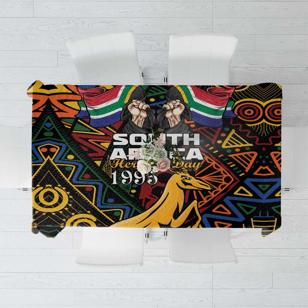 Black tablecloth with colorful African geometric pattern and springbok artwork, centered panel