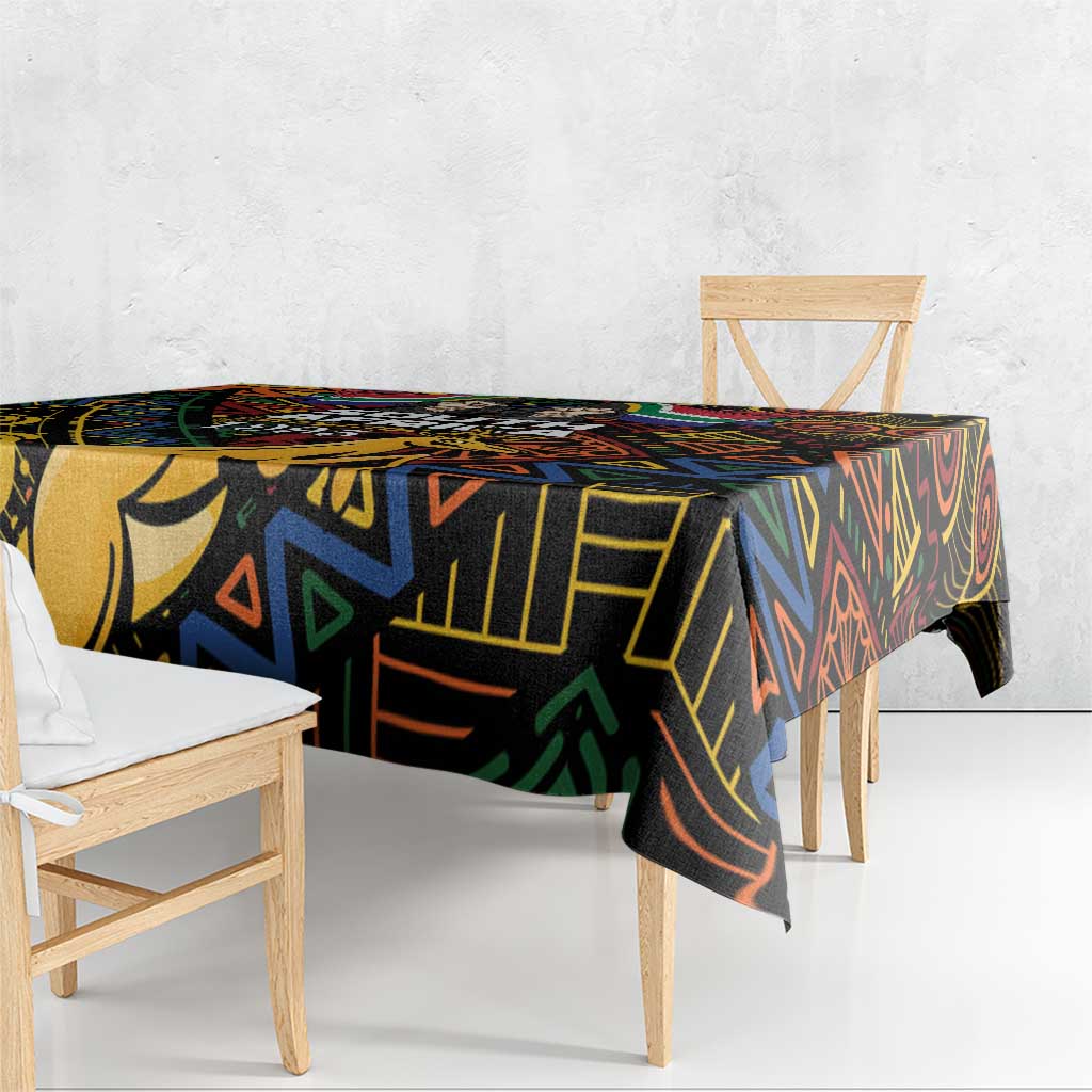 Black tablecloth with vibrant African geometric print, hanging over table edges
