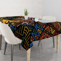 Black tablecloth with bold African geometric pattern, draped across table with place settings