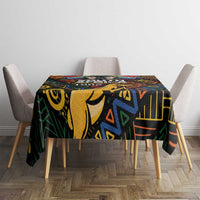 Black tablecloth with colorful African geometric and tribal-style motif, covering dining table