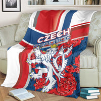 Red, blue and white lion graphic blanket spread over a couch