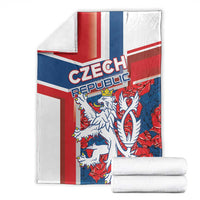 Folded red, blue and white lion graphic blanket with stacked rolls