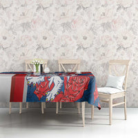 Red and blue tablecloth with lion and rose pattern on dining table, full view.