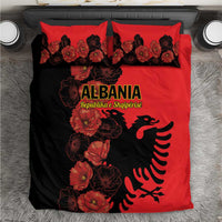 Red and black duvet cover with poppy floral print and Albanian eagle graphic, two pillows