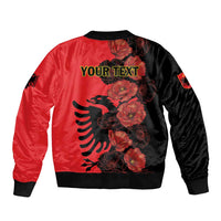 Unisex red and black bomber jacket with "YOUR TEXT" back graphic, floral eagle motif, ribbed hem