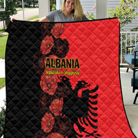 Two-tone quilt blanket with black and red panels, quilted diamonds, floral eagle graphic.