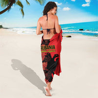 Red and black sarong with eagle emblem on back, tied at waist