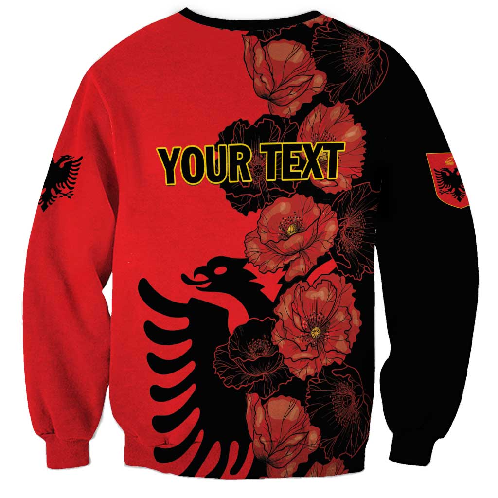 Red sweatshirt with black accents and poppy floral eagle graphic