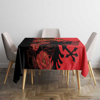 Red tablecloth with black eagle and floral print, centered on a dining table
