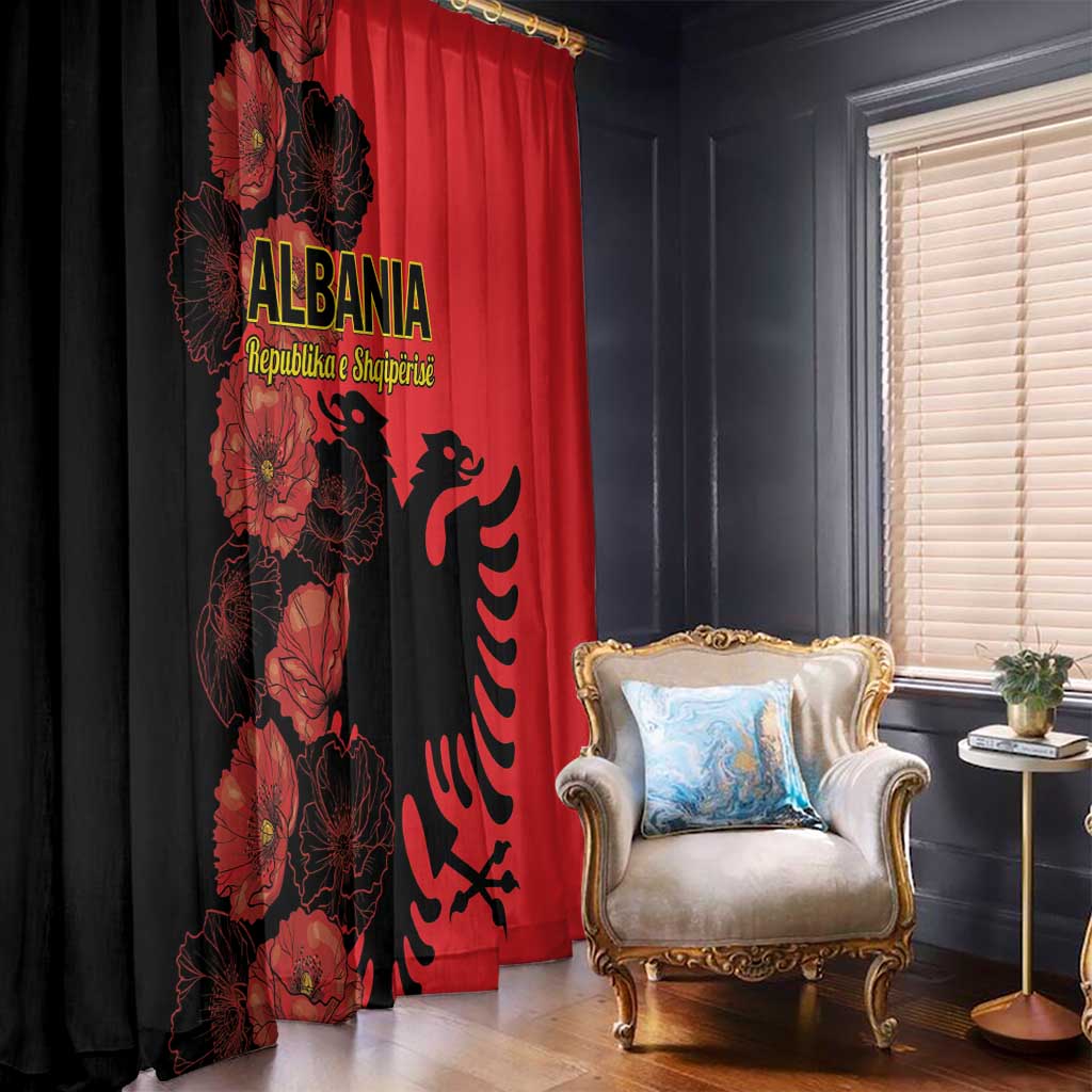Floor-length window curtains in red and black with poppy print and eagle emblem