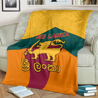 Sri Lanka flag-style blanket with golden lion emblem over orange, teal, and purple panels