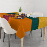 Flag-style tablecloth with orange, teal, and purple panels featuring central emblem