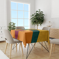 Flag-style tablecloth with orange, teal, and purple panels on dining table
