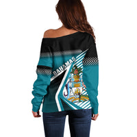 Off-shoulder women’s sweater, black with teal Bahama crest and striped back graphic