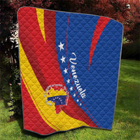 Venezuela themed quilt blanket on grass with red yellow blue diagonal panels and star crest