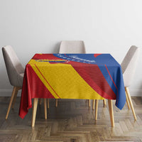 Venezuela flag tablecloth on dining table with two chairs, colorful diagonal red yellow blue