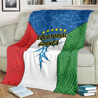 Equatorial Guinea flag blanket draped on couch, red blue green panels with stars and text