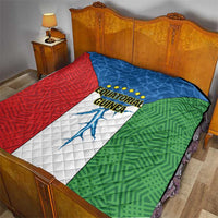 Equatorial Guinea flag quilt laid on bed with red, blue, and green stitched panels