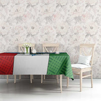 Colorful tablecloth on dining table, green geometric panel with red side and blue motif