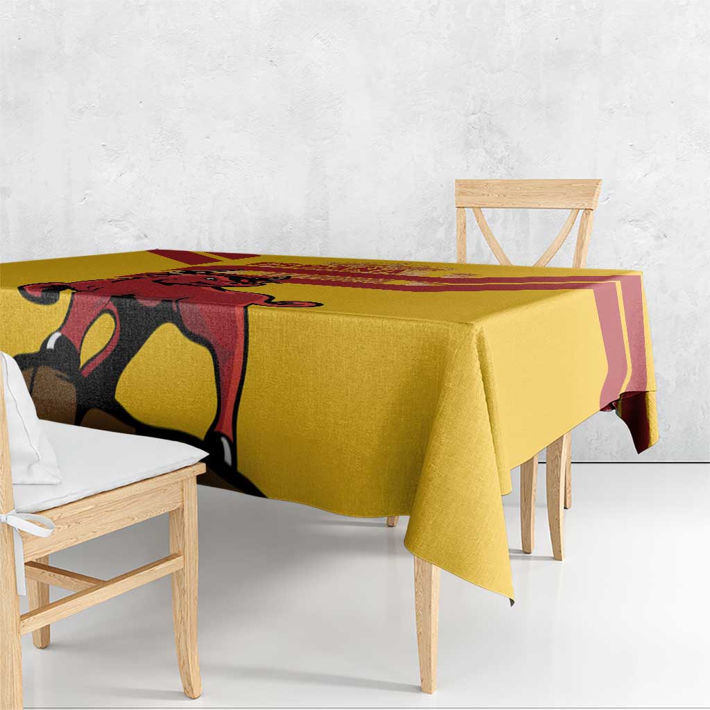 Yellow tablecloth draped over table edge, with large bull and Spain crest print
