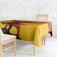 Yellow tablecloth draped over table edge, with large bull and Spain crest print