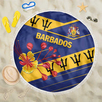 Round Barbados beach blanket laid flat in blue and yellow with fringe edge and floral crest