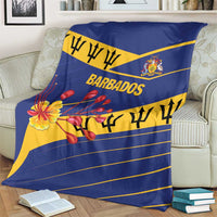 Blue Barbados blanket on armchair with floral artwork, crest, and yellow stripes