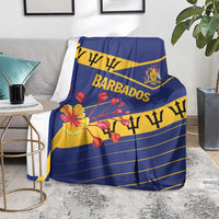 Blue Barbados blanket over gray sofa with floral print and centered “BARBADOS”