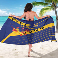Blue sarong draped across shoulders with yellow stripes, Barbados crest, and hibiscus print