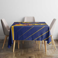 Blue tablecloth with yellow lines and Barbados emblem, draped over dining table