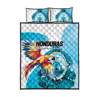 Blue quilt bed set with macaw artwork and circular crest, with two matching pillowcases