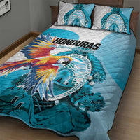 Blue quilt bed set with macaw print and circular emblem, matching pillowcases