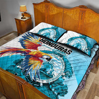 Blue and white quilt bed set with macaw artwork and circular crest, two pillowcases