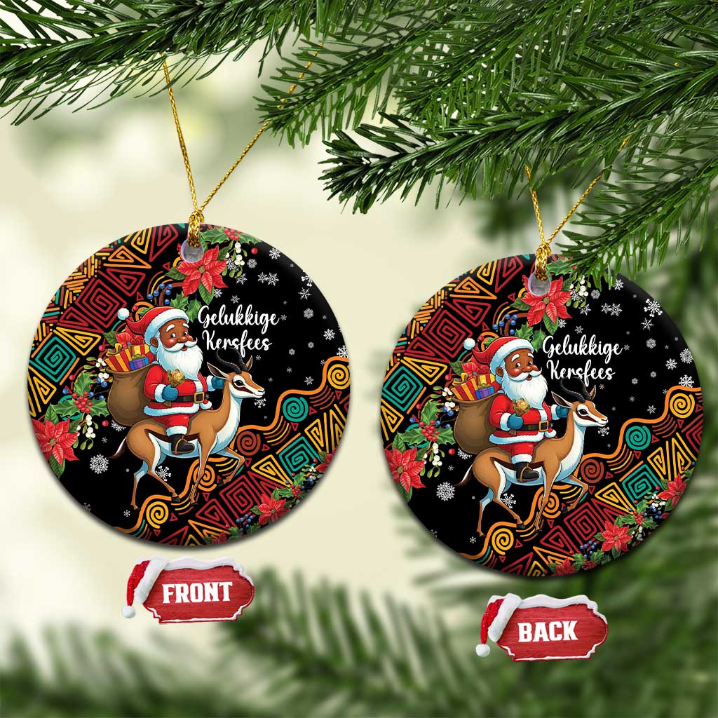 Round ceramic Christmas ornament with Santa Claus riding a springbok, hanging on a gold string.