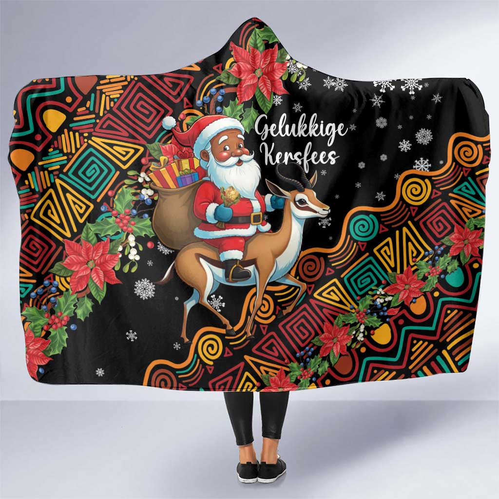 Hooded Christmas blanket with black base, colorful tribal print and Santa riding springbok.