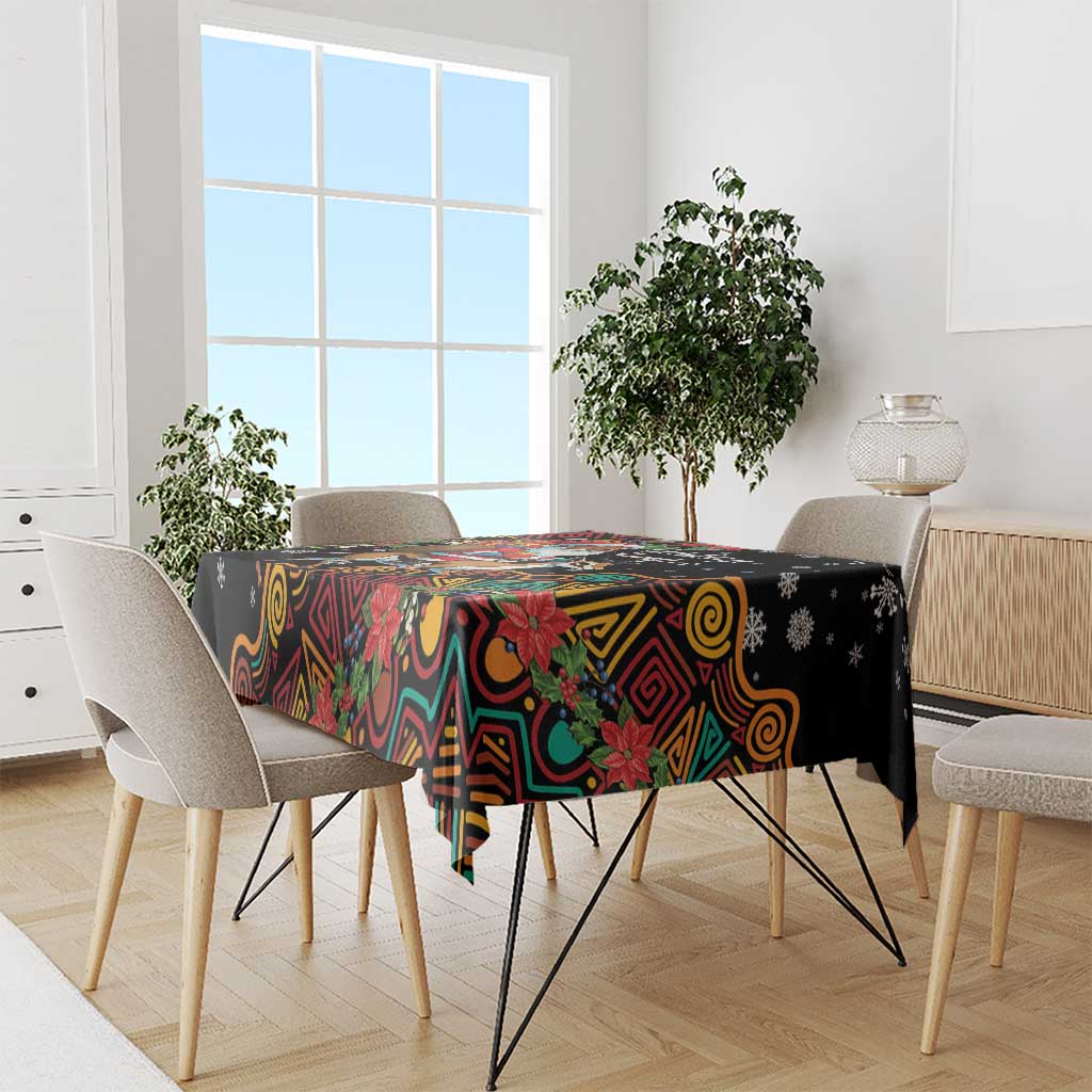 Christmas tablecloth in black with colorful swirl patterns and poinsettia, draped on table