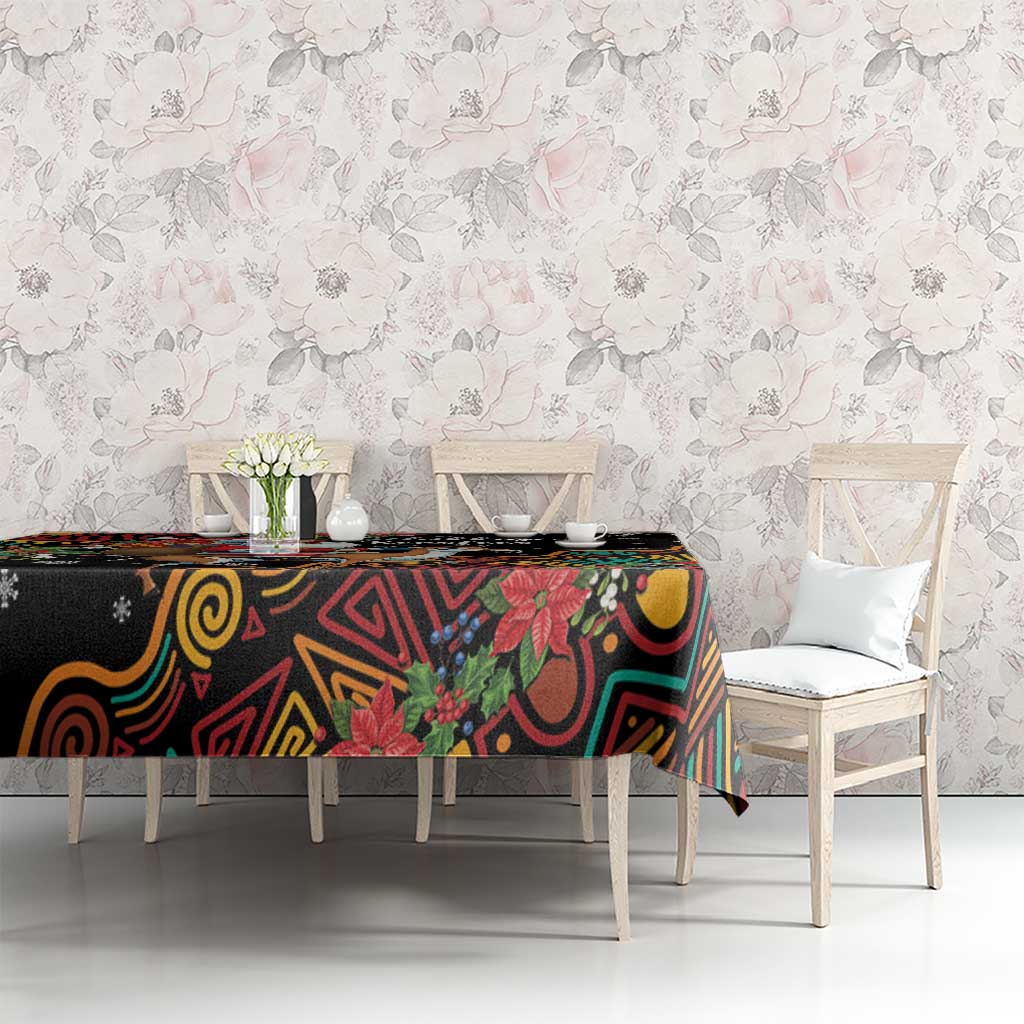 Christmas tablecloth with black base, colorful swirls, and poinsettias; set for dining